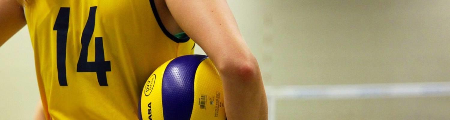 Volleyball player pauses, holding the ball
